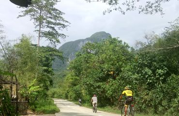 Two people cycling on a road