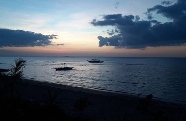 Sunset with two boats on the water
