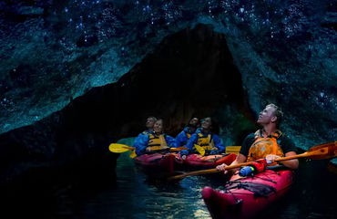 People kayaking in glowworm cave