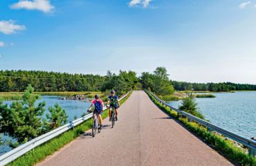 Cyclists riding over a tarmac bridge