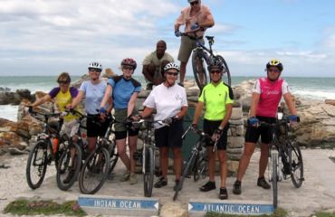 Group of cyclists infront of monument