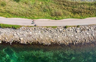 Aerial shot of cyclists on coastal path