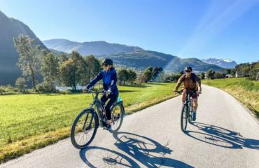 Cyclists on quite road with mountains in background