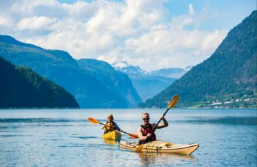 People kayaking on fjord