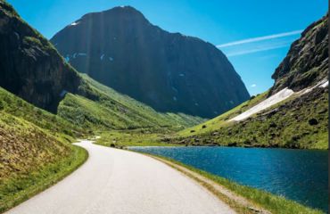 Small road leading into the mountain with river by the side