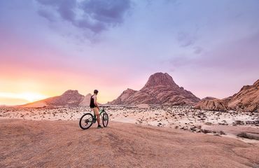 Cyclist looking across desert-like scenery