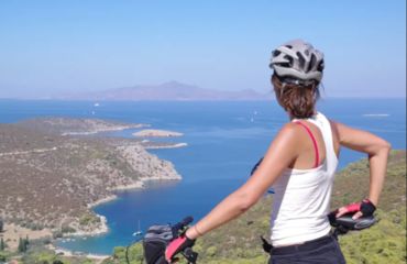 Woman on bike looking out to sea