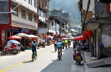 Cyclists riding through mountain town