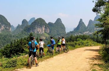 Cyclists all looking out at karsts together
