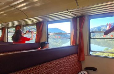 People on a train taking photos out of the window