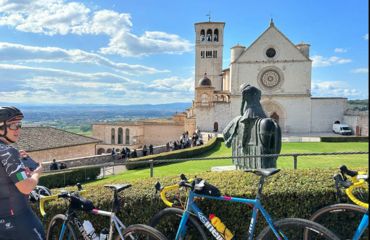 Bikes leaned up against hedge by church building