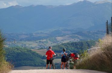 Cyclists on road looking out to mountains
