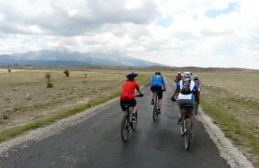 A few cyclists riding together in a group on a road