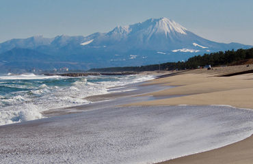 Beach with snow-capped mountain in background