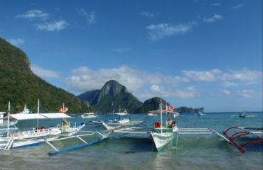 Boats in the water with mountain background