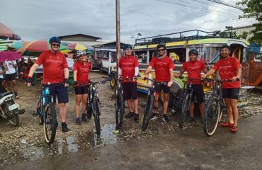 Cyclists with bikes infront of vehicles