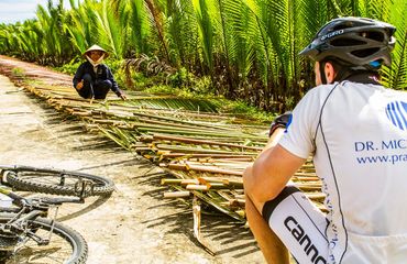 Vietnamese and cyclist with palms