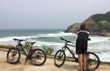 Cyclist by the sea