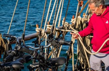 Crew using ropes on the deck of the sail boat