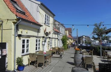 White building with table and chairs outside