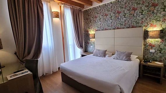 Spend your final night in a boutique hotel housed in a 19th-century building near the Mestre train station