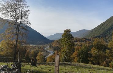 View of river and mountains with green and rust foliage