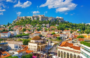 Colourful city with historic buildings and hill in background