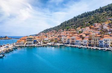 Blue sea with village and marina on side of hill