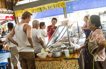People gathered at street foot with guide