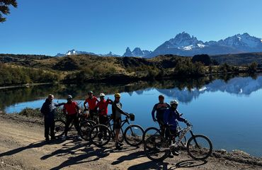 Group of cyclists by mountain lake