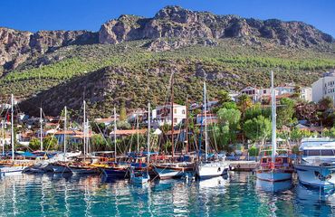 Sailing boats by green mountain village