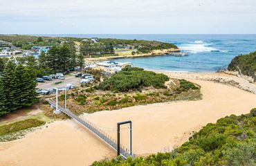 Bridge over a beach with a seaside town