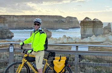 Cyclist at a viewpoint with rocks in the sea