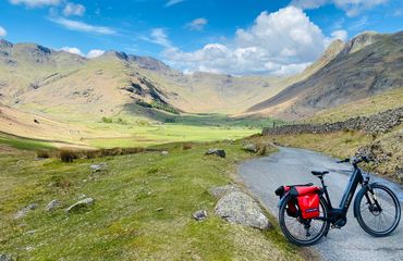 Cycle in middle of narrow road in hills