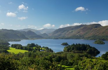 Trees, mountains and lakes under a blue sky