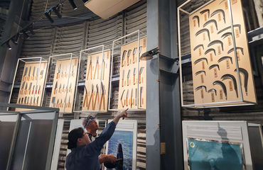 People looking at a display of knives