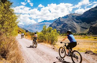 Cyclists on rural road through mountains