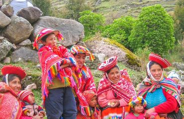 Group of people, old and young in red colorful Peruvian dress