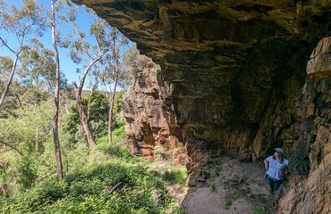 Woman underneath a rock