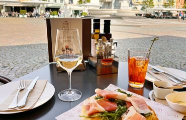 A glass of wine and a plate of food
