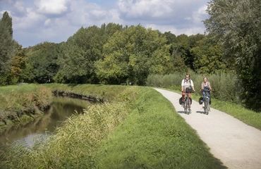 Cycling along a road with a river on the side 