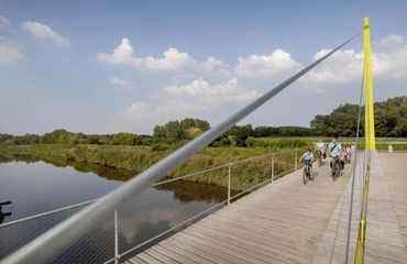 Group of cyclists crossing a bridge
