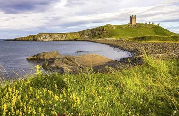View of distant castle on hill overlooking water