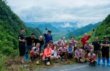 Group waving with mountains behind
