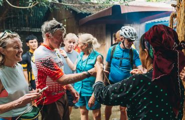 Group of cyclists and local laughing and meeting