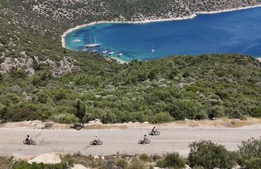 Aerial shot of cyclists riding on a coastal road