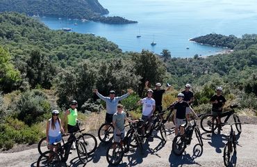 Cyclists posing by the sea