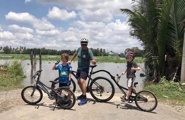 Adult and 2 children on bikes 