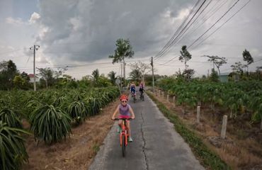 Child and adults cycling on paved rural path