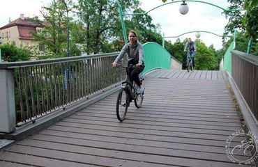 Cyclists riding over  bridge